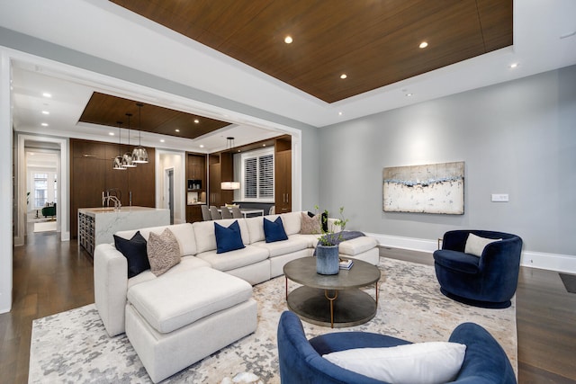 living room featuring recessed lighting, dark wood-type flooring, wood ceiling, baseboards, and a raised ceiling