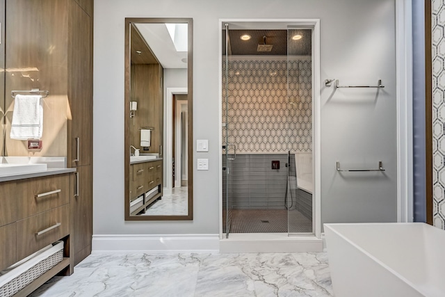 bathroom with a stall shower, marble finish floor, vanity, and baseboards