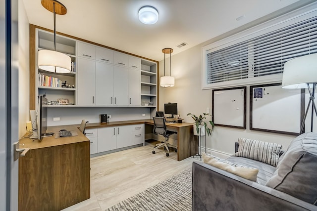 office area with visible vents and built in desk