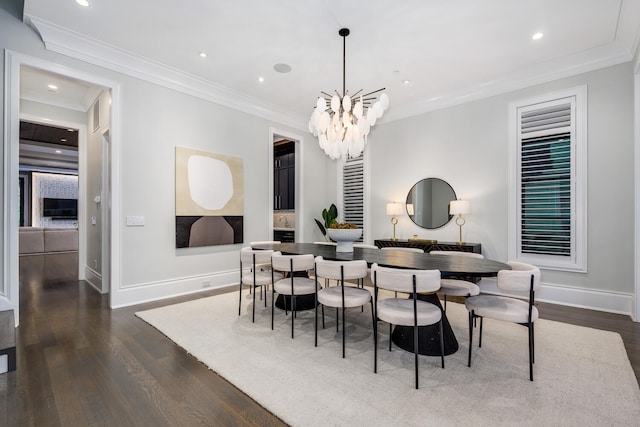 dining area featuring dark wood-style floors, a notable chandelier, baseboards, and crown molding