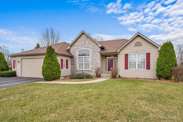 ranch-style house with an attached garage, a shingled roof, a front lawn, and aphalt driveway