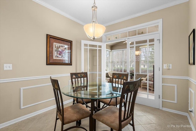dining room featuring light tile patterned floors, baseboards, and ornamental molding