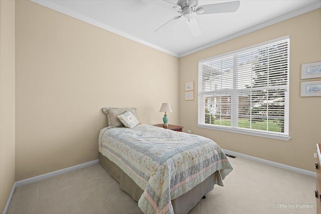 carpeted bedroom featuring ornamental molding, baseboards, a ceiling fan, and visible vents