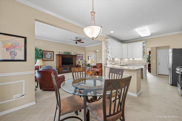 dining area featuring crown molding, light tile patterned floors, baseboards, and a ceiling fan