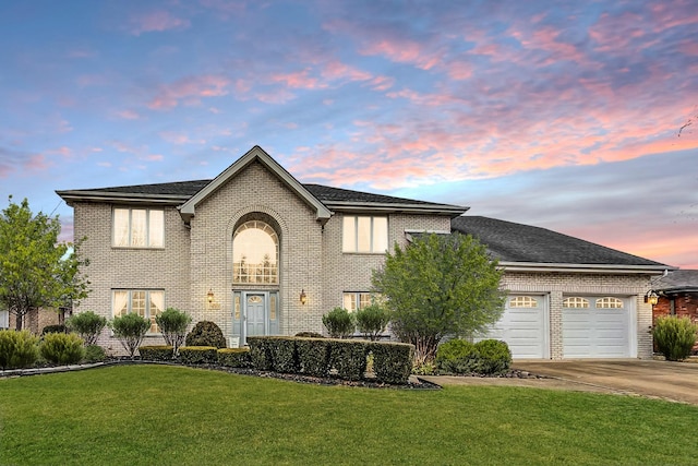 view of front of home with a balcony, a garage, and a lawn