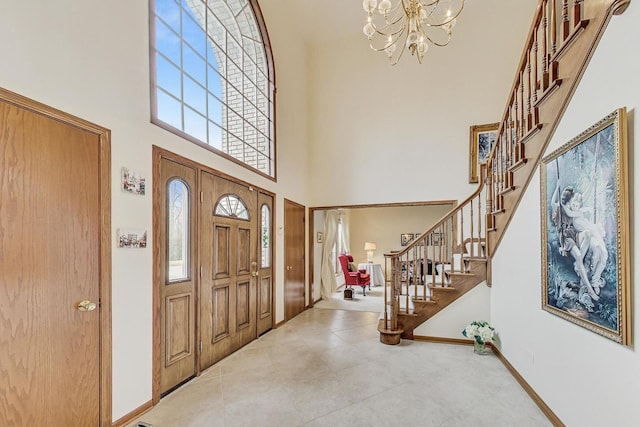 entrance foyer featuring a towering ceiling and an inviting chandelier