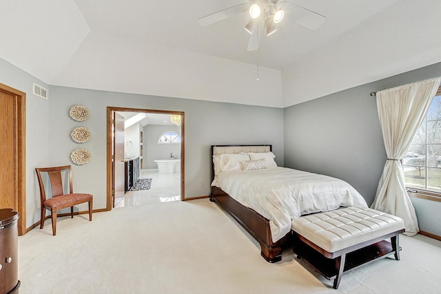 bedroom with carpet, lofted ceiling, connected bathroom, and ceiling fan