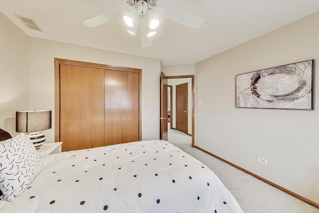 carpeted bedroom with a closet and ceiling fan