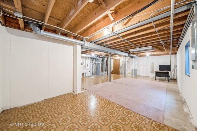 unfinished basement featuring water heater, heating unit, and tile patterned floors