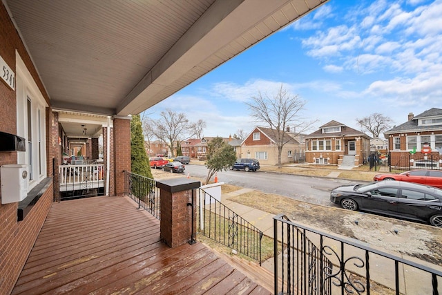 deck featuring a residential view and covered porch