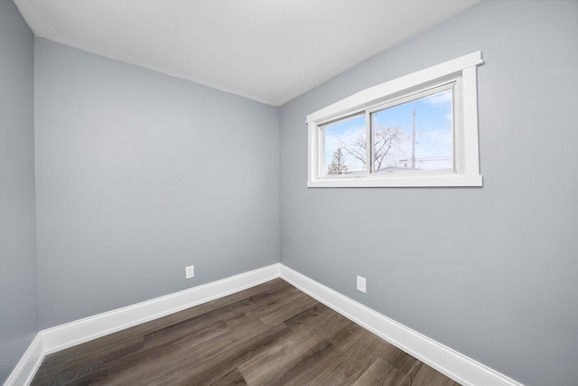 empty room featuring baseboards and wood finished floors