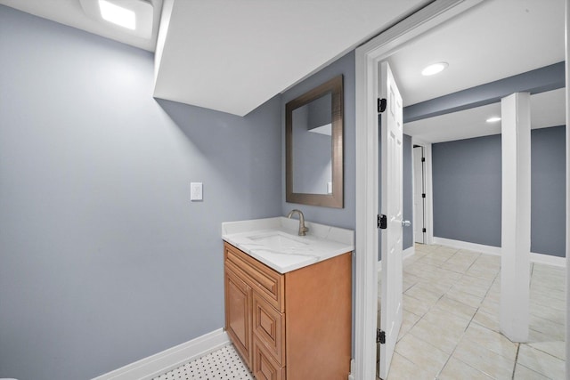 bathroom featuring tile patterned flooring, baseboards, and vanity