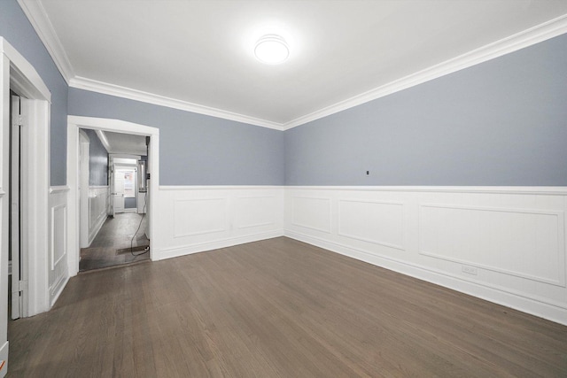 unfurnished room with dark wood-type flooring, a wainscoted wall, and ornamental molding