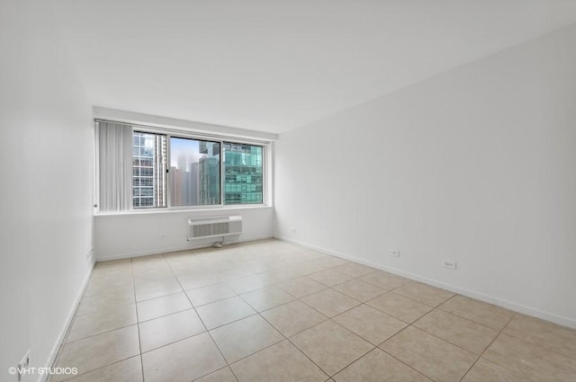 tiled empty room featuring an AC wall unit