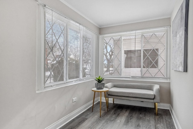 living area with dark wood-type flooring, ornamental molding, and plenty of natural light