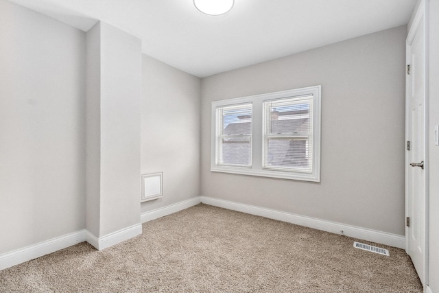 unfurnished room featuring light colored carpet