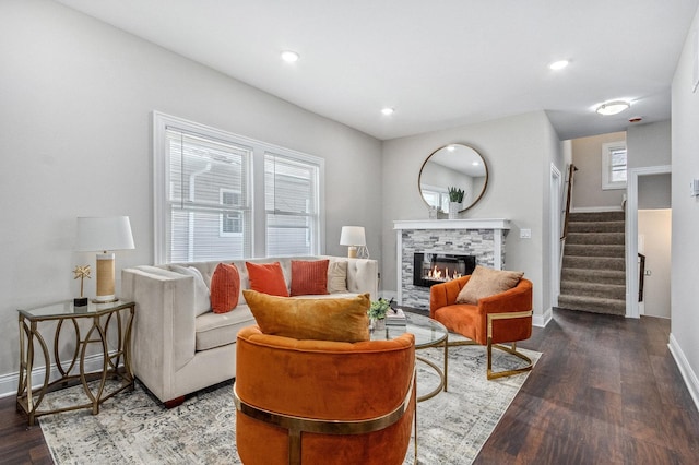 living room featuring hardwood / wood-style floors and a stone fireplace