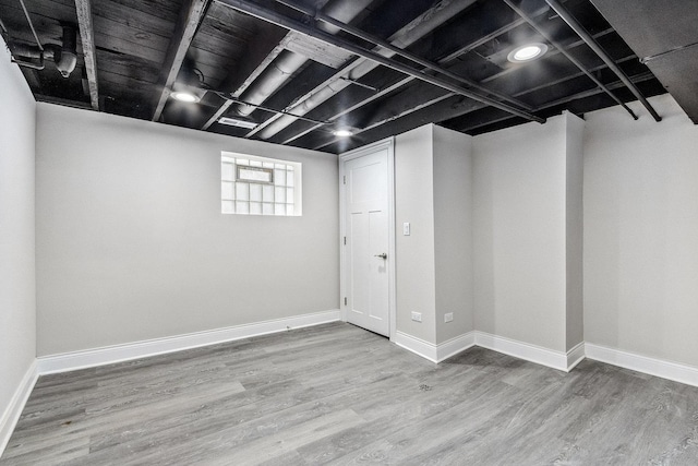 basement with hardwood / wood-style flooring