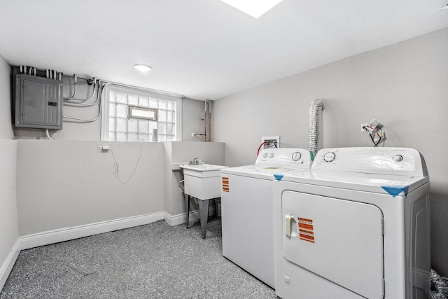 clothes washing area featuring electric panel and washing machine and clothes dryer