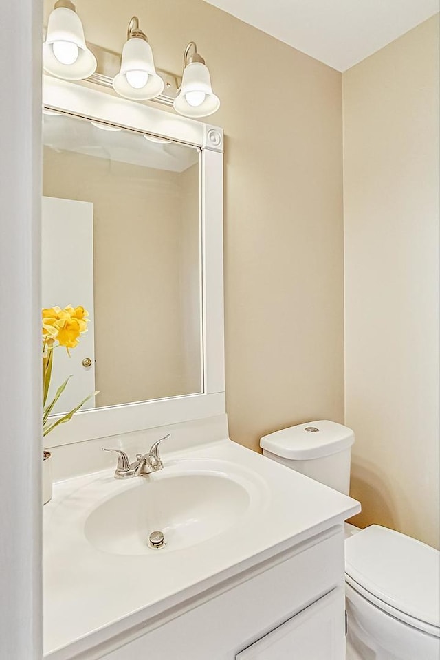 bathroom with toilet and vanity