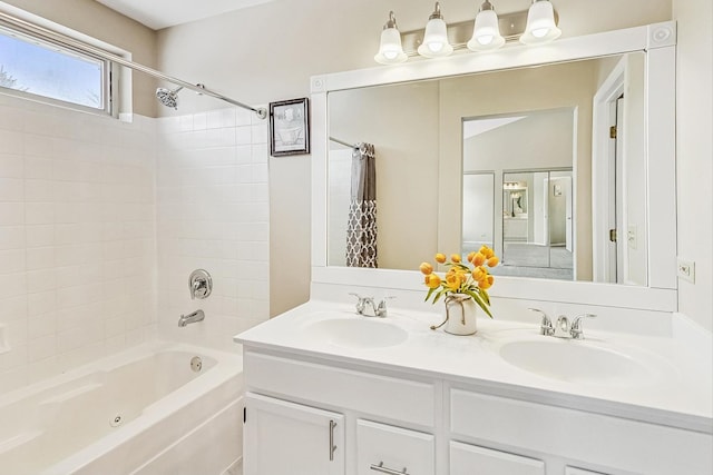 bathroom featuring double vanity, a sink, and shower / bath combo with shower curtain