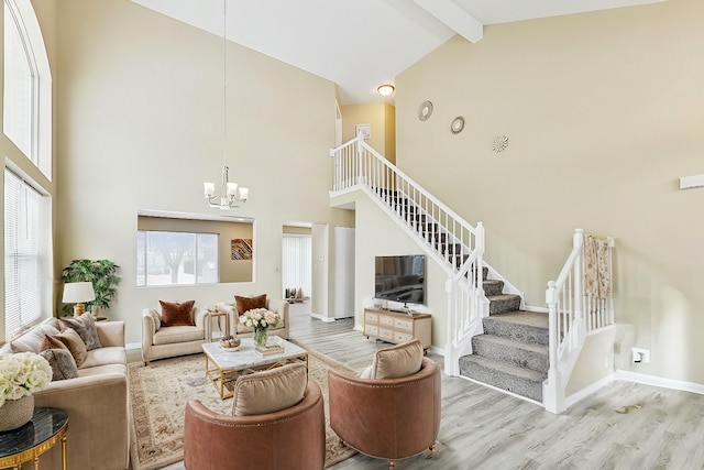 living area with baseboards, wood finished floors, stairs, a chandelier, and beam ceiling