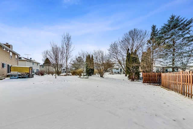 snowy yard with fence