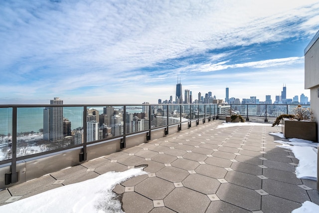 view of patio with a water view and a city view