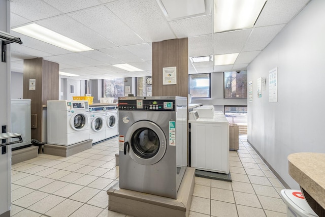 community laundry room featuring light tile patterned floors and washer and dryer