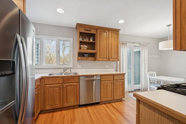 kitchen featuring brown cabinetry, appliances with stainless steel finishes, and light countertops