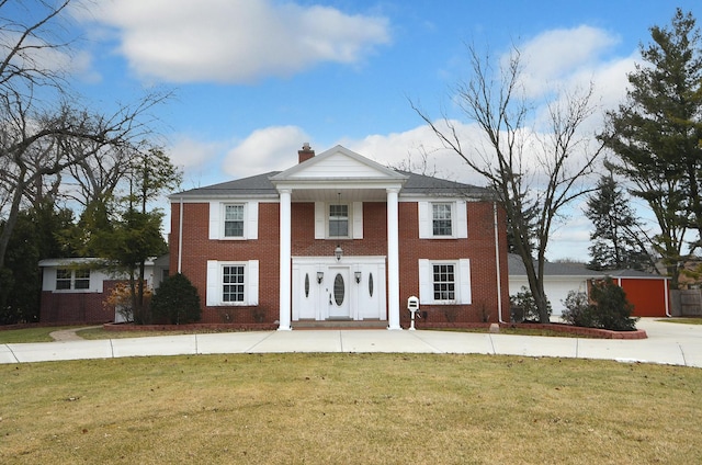 neoclassical home with a front yard