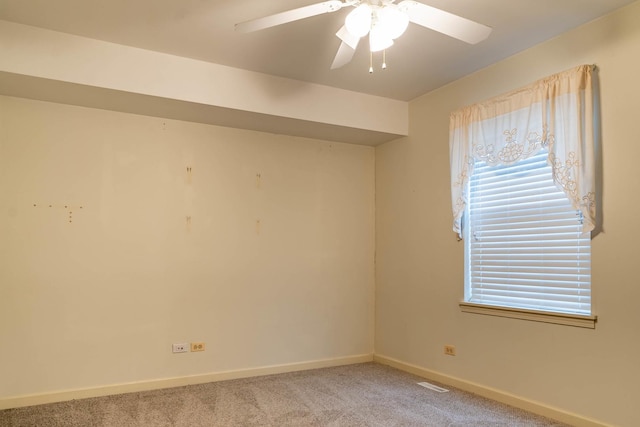 carpeted empty room featuring ceiling fan