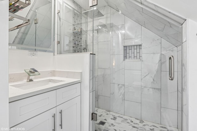 bathroom featuring a shower stall and vanity