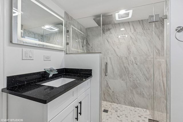 full bathroom with a stall shower and vanity