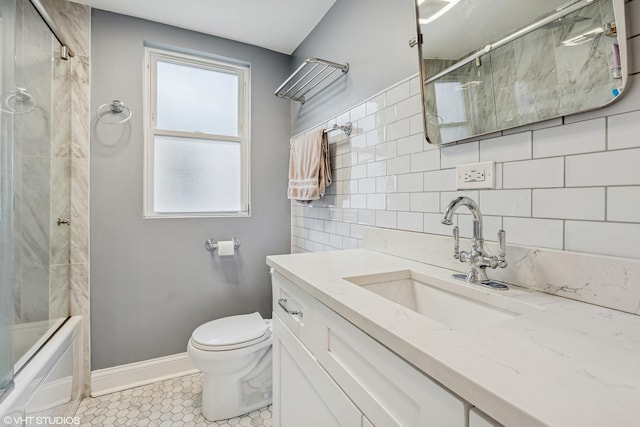 full bath with backsplash, toilet, enclosed tub / shower combo, vanity, and baseboards