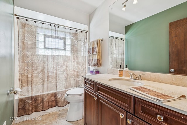 bathroom featuring shower / bath combo with shower curtain, vanity, toilet, and tile patterned floors