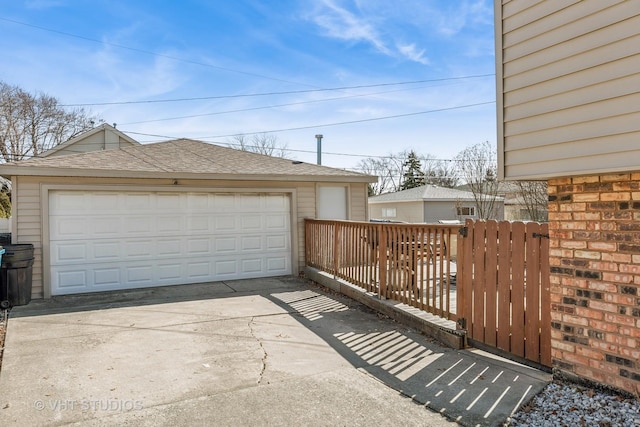 detached garage featuring fence