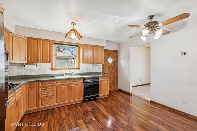 kitchen featuring dark wood-type flooring, a sink, backsplash, black appliances, and dark countertops