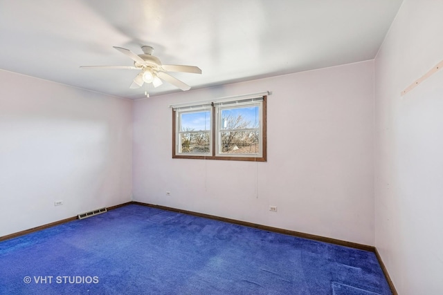 empty room featuring baseboards, carpet, visible vents, and a ceiling fan