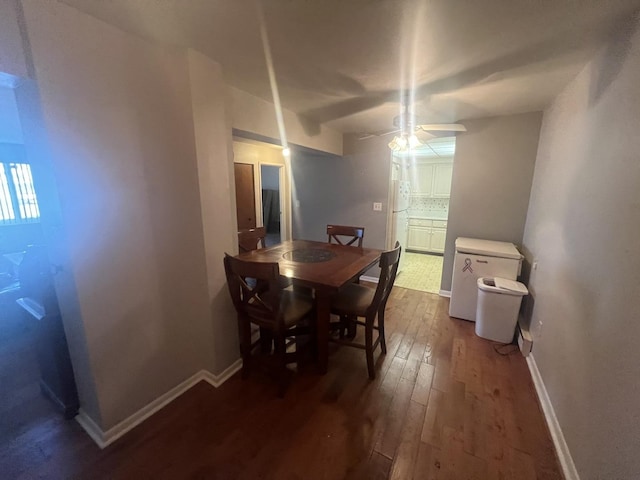 dining space with dark hardwood / wood-style floors and ceiling fan