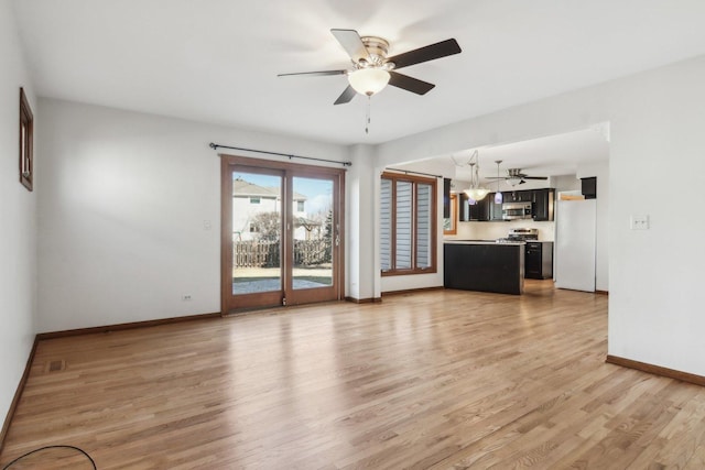 unfurnished living room featuring ceiling fan and light hardwood / wood-style floors