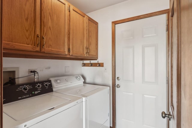 laundry room with cabinets and washer and dryer