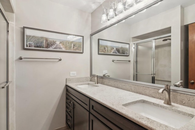 bathroom with vanity and a shower with door