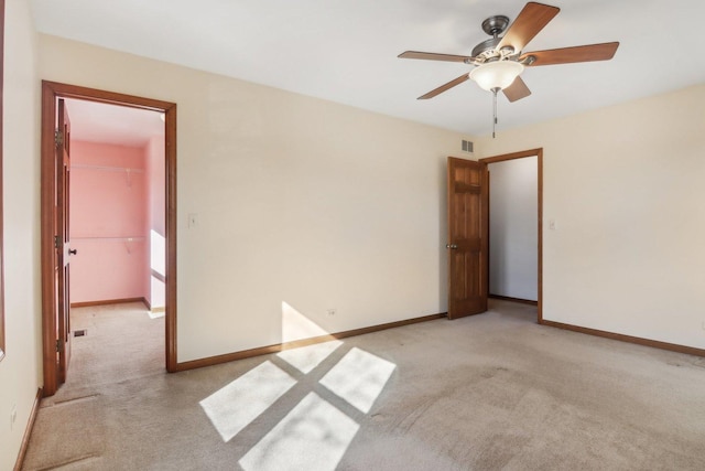 carpeted spare room with ceiling fan