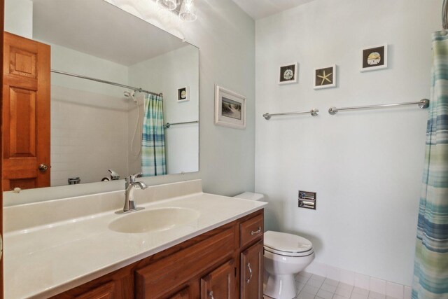 bathroom featuring tile patterned floors, vanity, toilet, and a shower with shower curtain