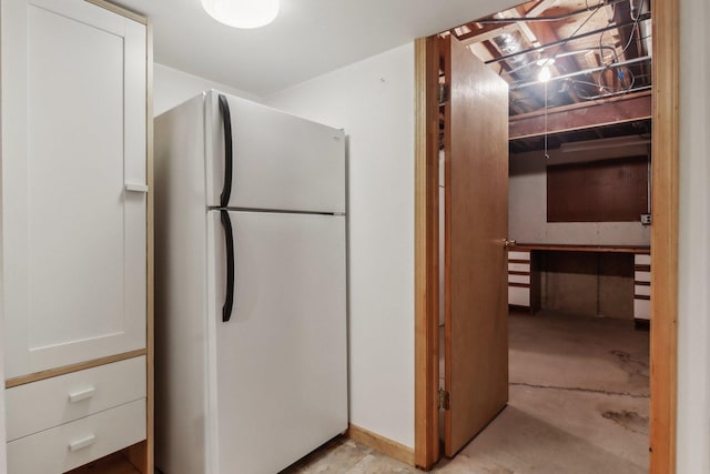 kitchen with white refrigerator and white cabinets