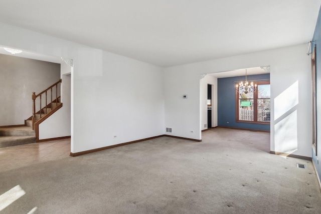 unfurnished living room with a chandelier and light carpet