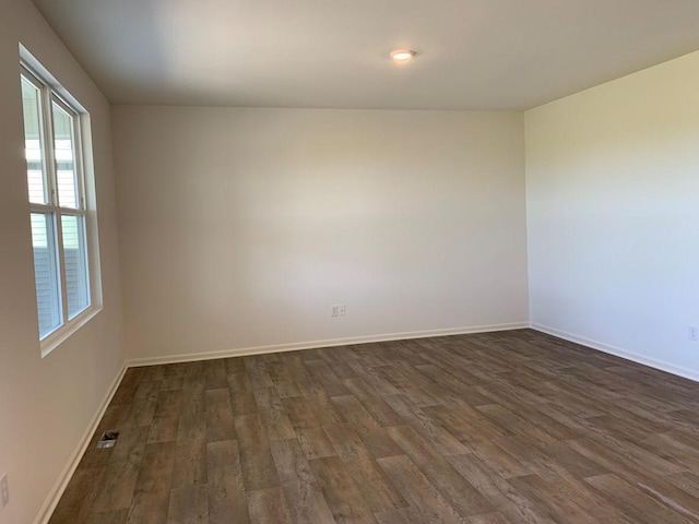 empty room featuring dark hardwood / wood-style flooring