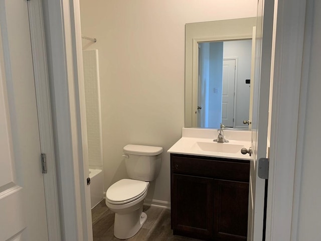 full bathroom with vanity, toilet, tub / shower combination, and hardwood / wood-style floors