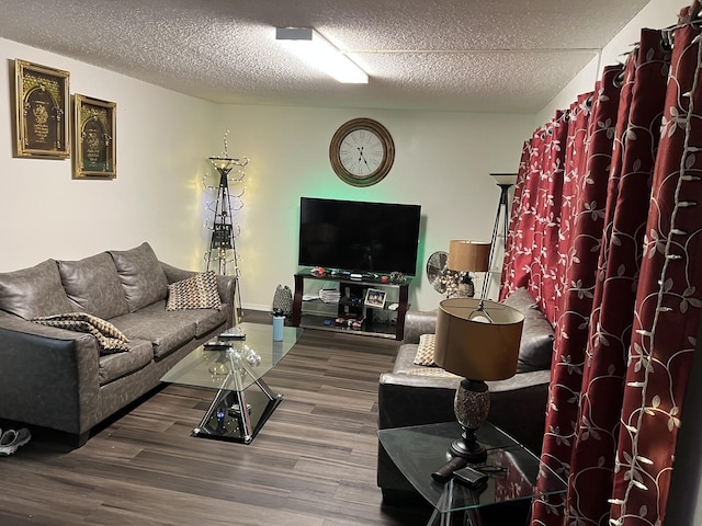 living room featuring dark hardwood / wood-style floors and a textured ceiling